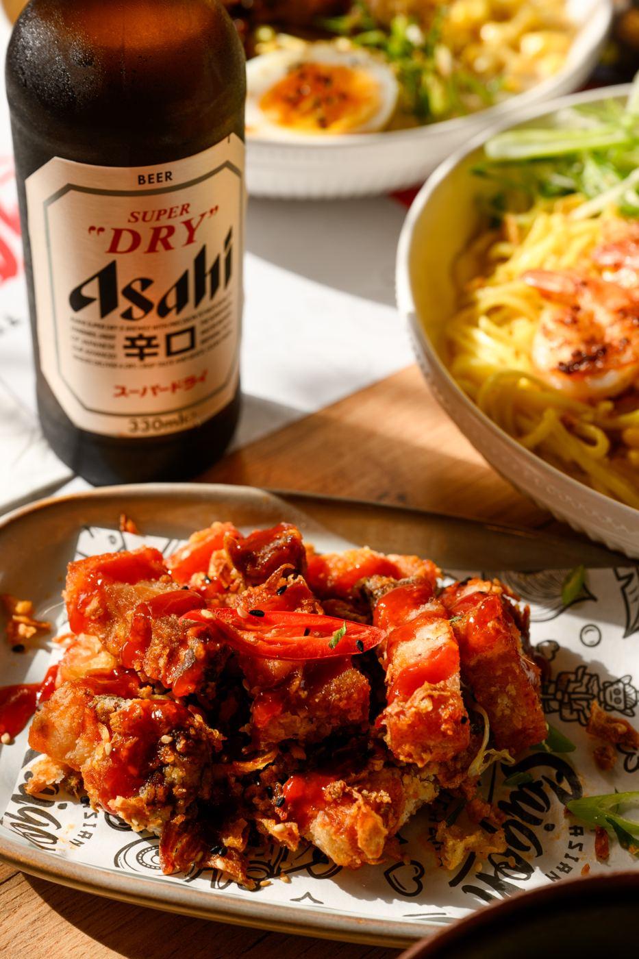 Crispy fried bites in sweet chilli sauce with an Asahi beer at Saigon Malta
