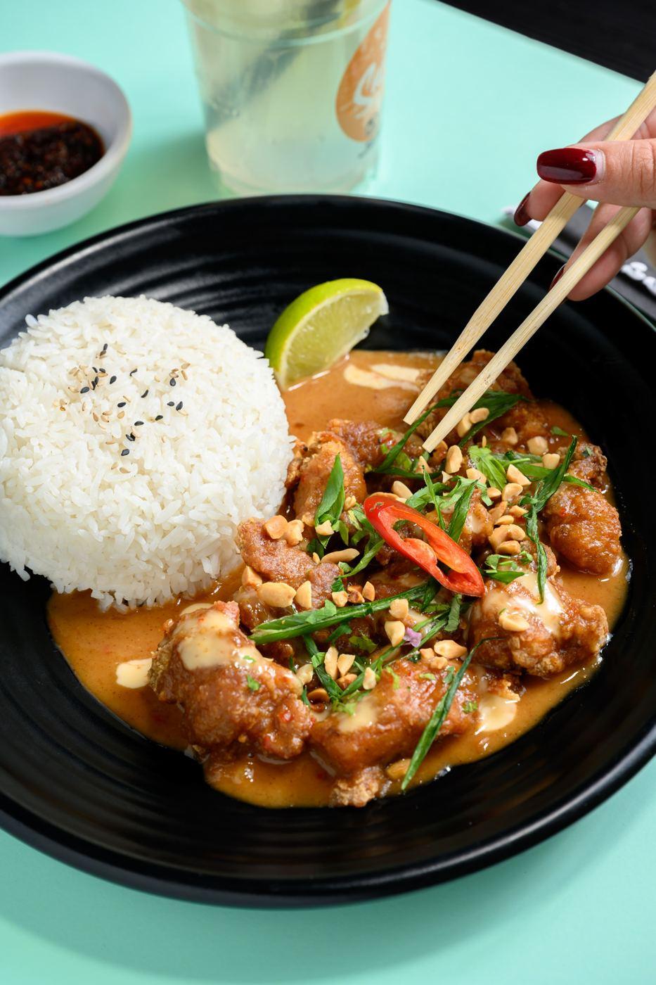 Peanut chicken with fresh herbs, plated at Saigon